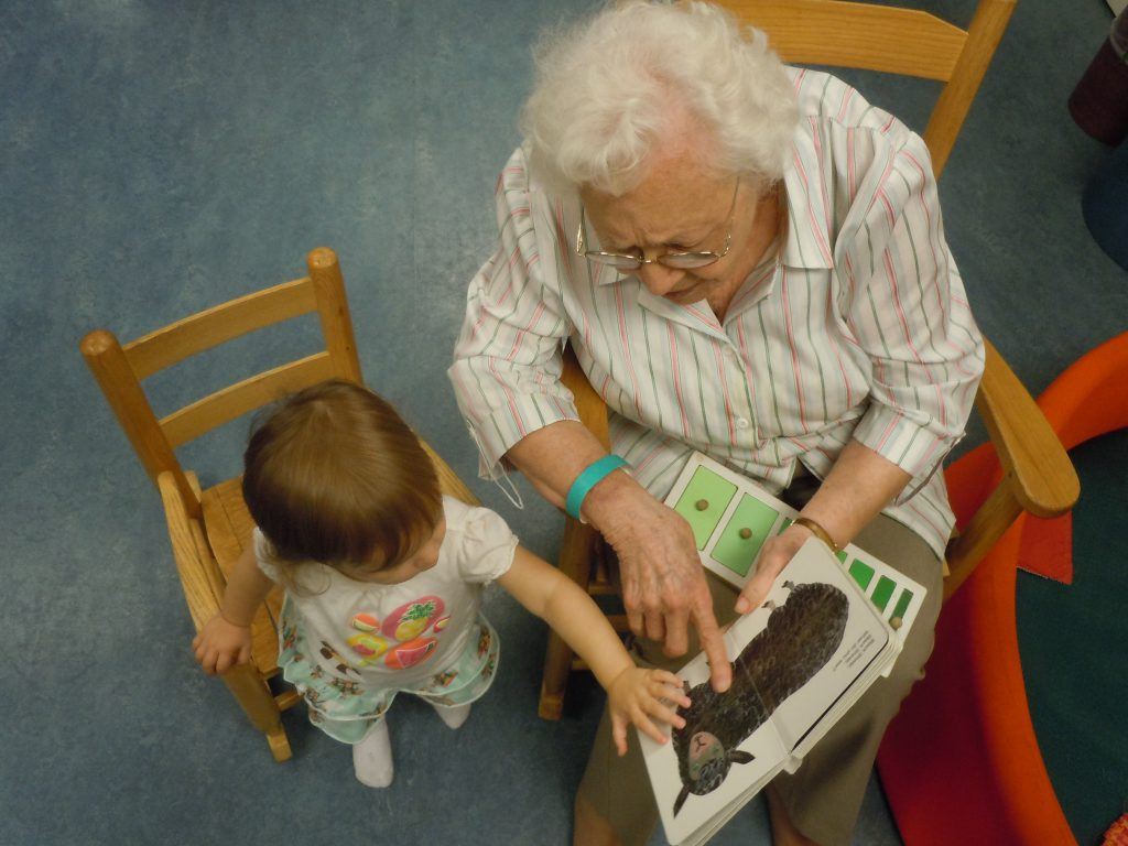 Dorothy (age 95) reading to her great-granddaughter Emma.